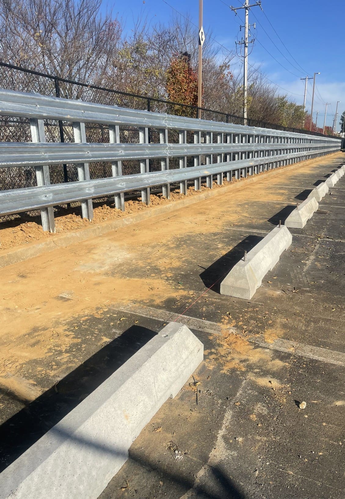 Three-high W-beam guardrail wall installed on steel posts